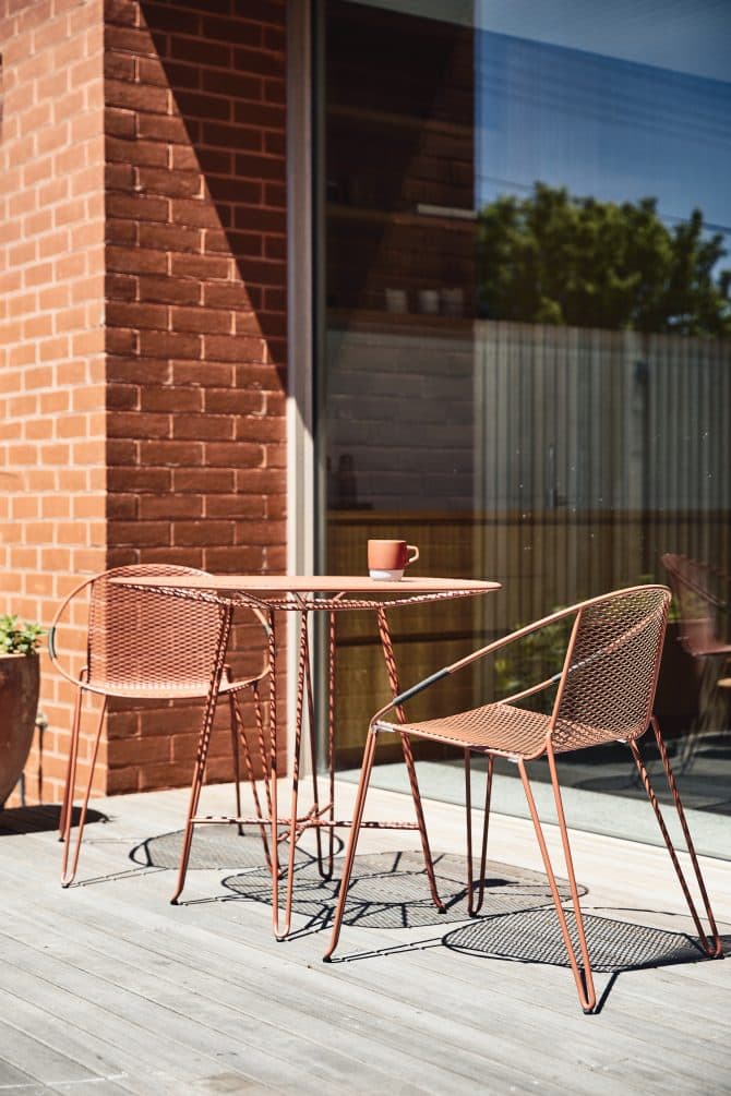 the Volley Chair - a modern outdoor dining chair with a distinct mid-century modern vibe designed by Adam Goodrum.