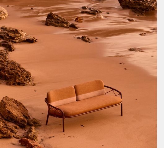 Rockpool upholstered outdoor 2 seater lounge by Tait on sandy coast