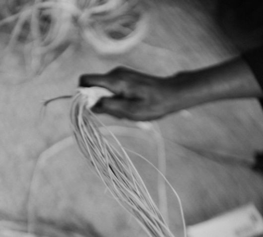 Indigenous Australian hands weaving fibre craft